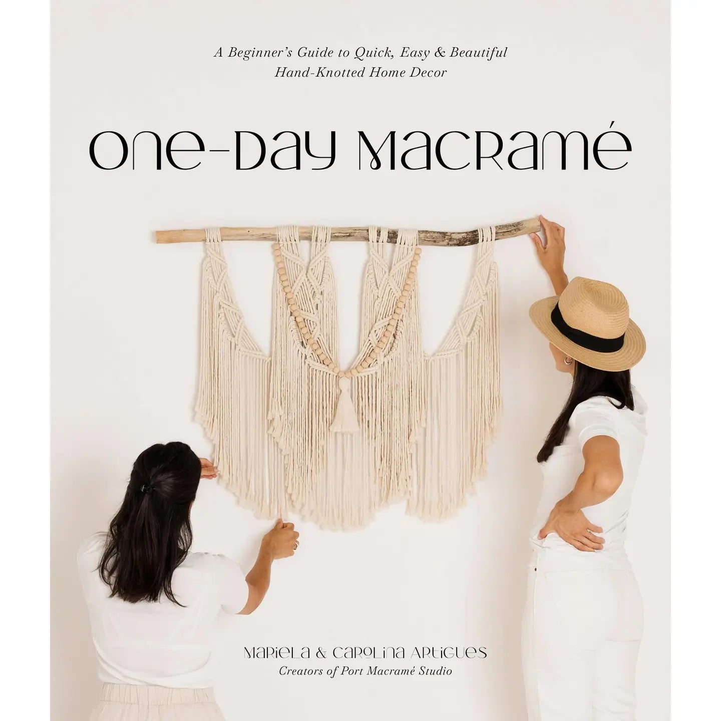 Book cover of 'One Day Macrame' with two people hanging up a macrame design on a white background.