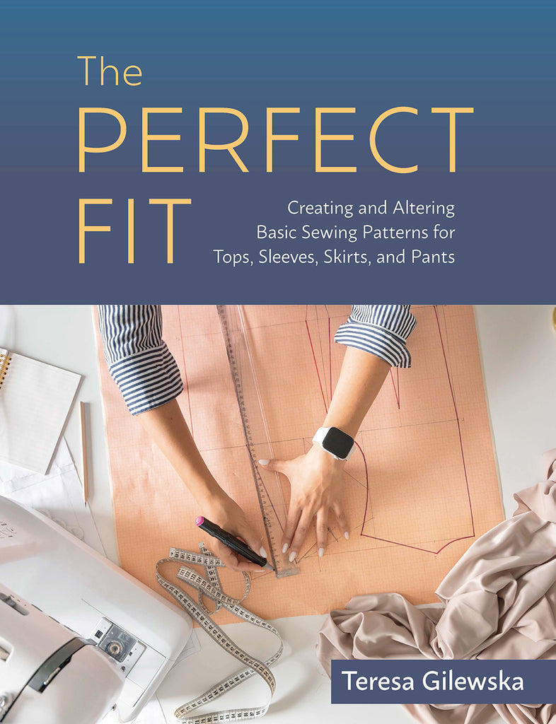 Book cover of 'The Perfect Fit' with sewing pattern and fabric on a table.