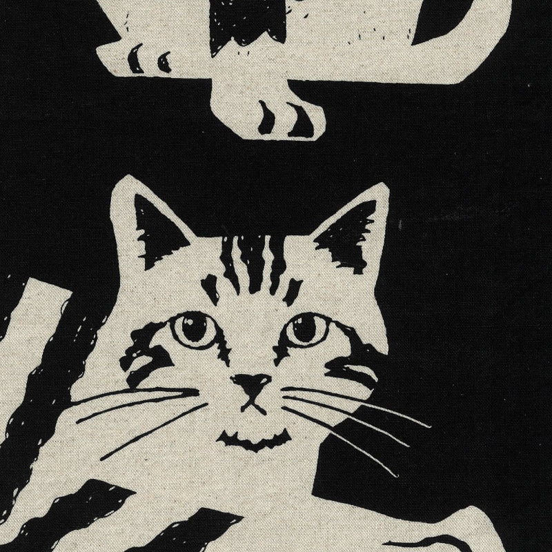 Black and white illustration of a cat with a stylized pattern on a black fabric
