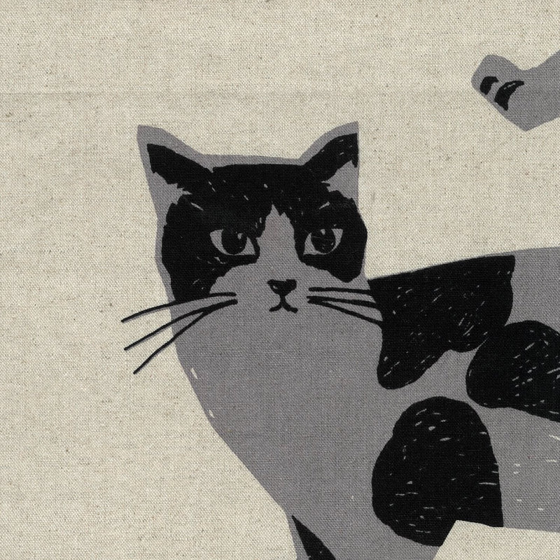 Illustration of a cat with a patterned tail on a natural fabric