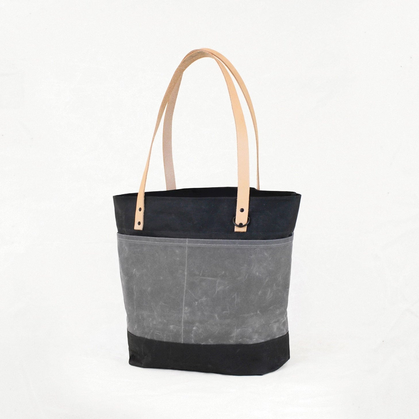 Two-toned tote bag with black top half and gray bottom half on a white background