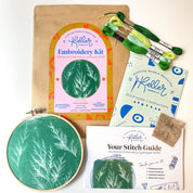 Embroidery kit with hoop, thread, and instructions on a white background