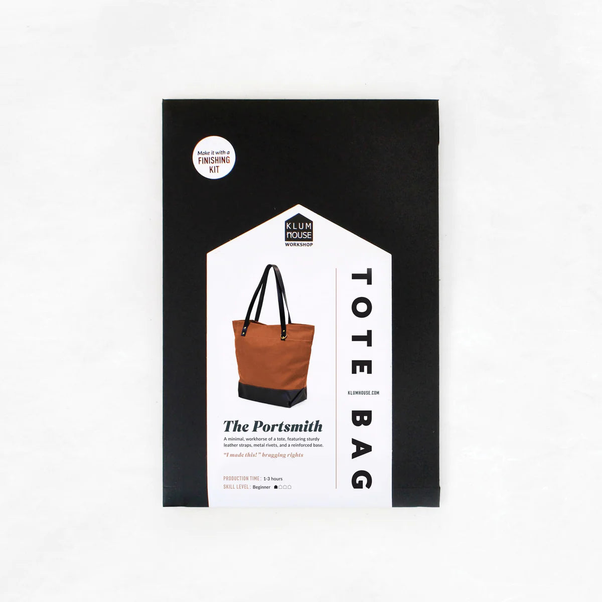 A black and white tote bag pattern by Klum House, titled 'The Portsmith Tote Bag', with leather straps and a reinforced base illustrated on the cover.