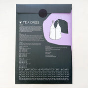 Pattern envelope with 'Teia Dress' design details and size chart on a white background