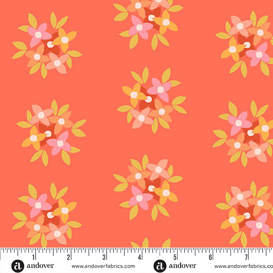Fabric swatch with warm tones flowers on tomato orange background, with ruler at the bottom.