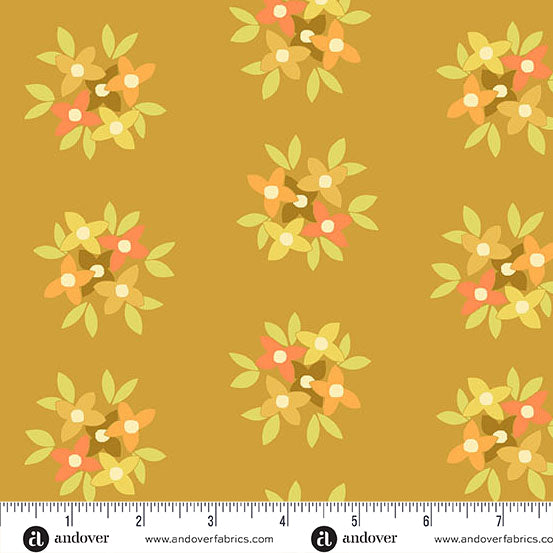 Fabric swatch with warm toned flowers on yellow background with ruler at the bottom.