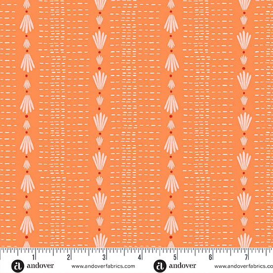 Patterned fabric with a ruler at the bottom for scale, on an orange background.