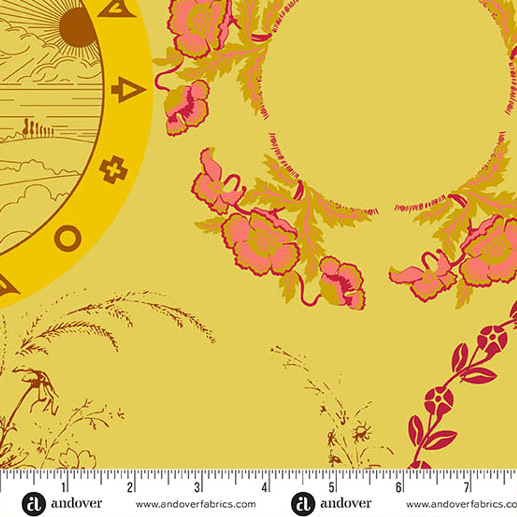 Yellow fabric swatch with yellow and pink floral circular designs with a ruler at the bottom for scale.