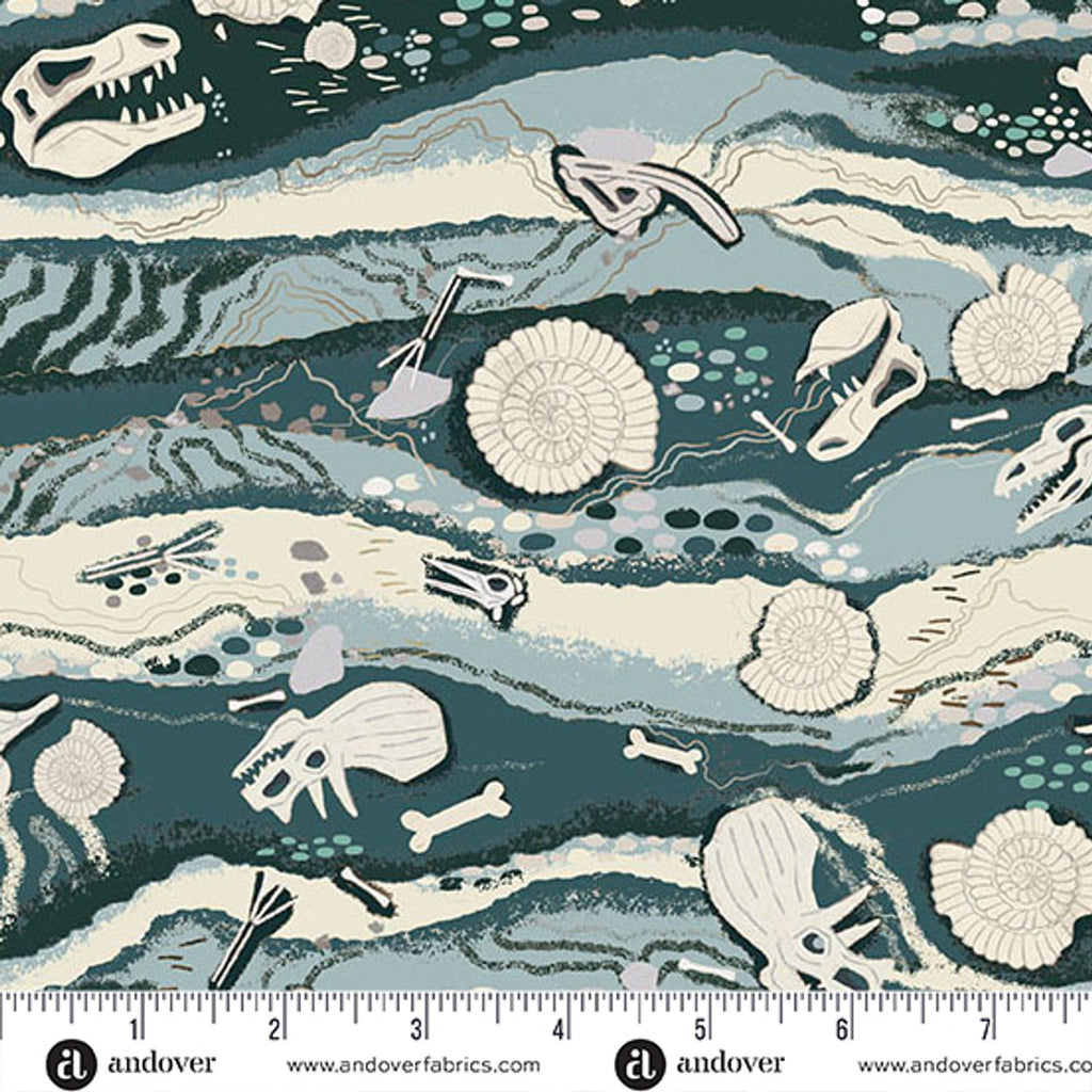 Fabric pattern with prehistoric-themed design featuring skeletons and fossils on a blue and green background, with a ruler at the bottom for scale.