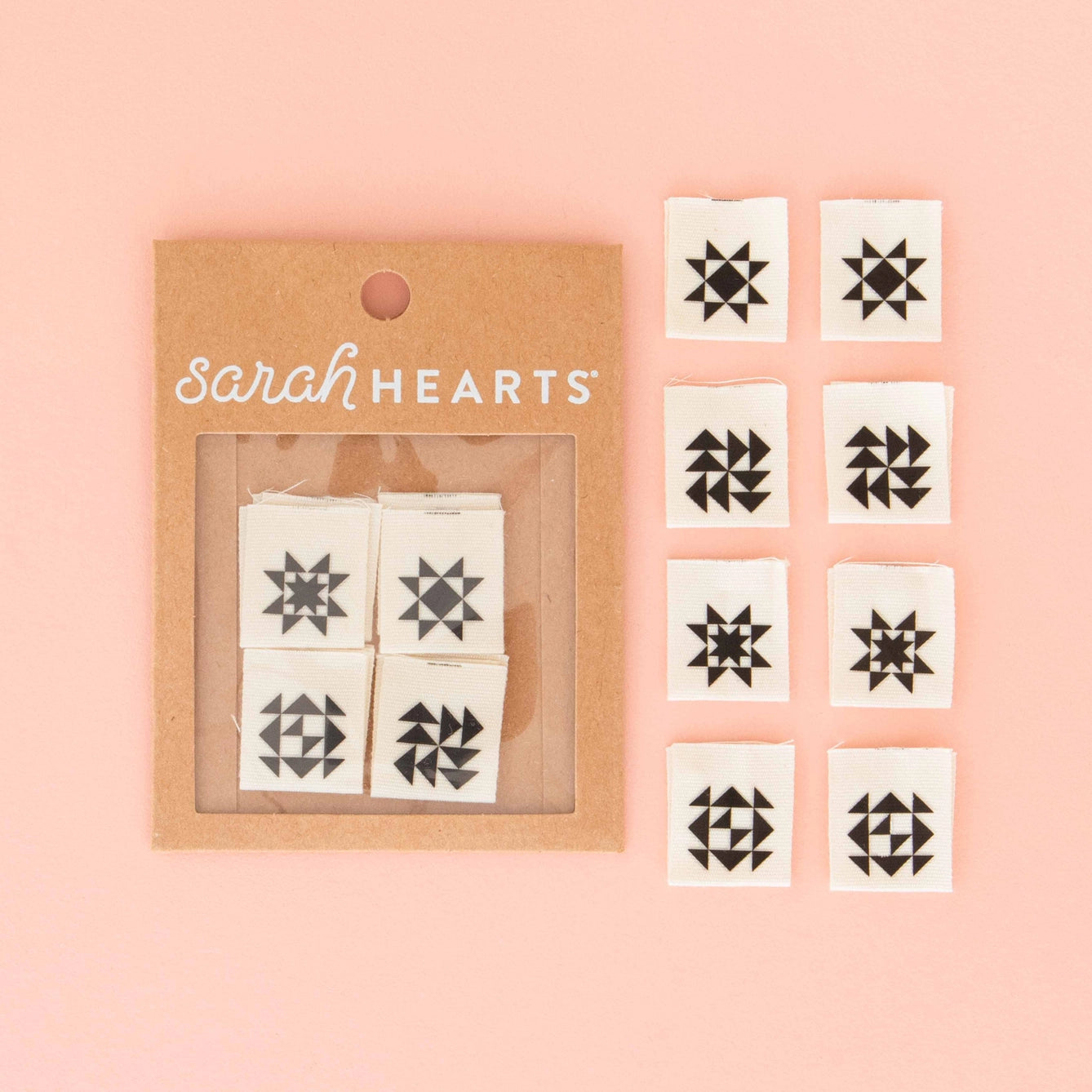 Set of black quilt block tags on white paper with 'sarah HEARTS' branding on a pink background