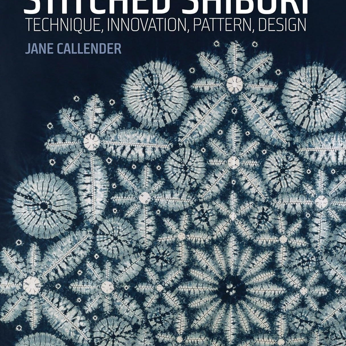 book cover for "Stitched Shibori" with intricate lace looking indigo dye pattern