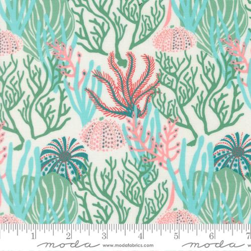 Fabric with green, blue, and pink coral reef scene on a light background