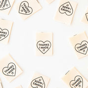 Small rectangular tiles with heart-shaped text 'THANKS I MADE IT' arranged in a grid.