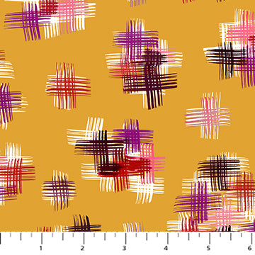 Patterned fabric with colorful abstract designs on a yellow background, featuring a ruler at the bottom.