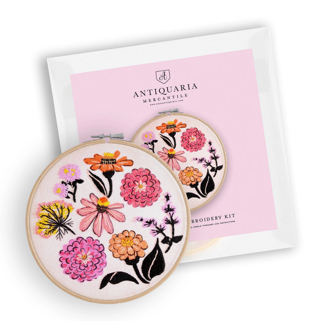Embroidery kit with floral designs on hoops and Antiquaria Mercantile packaging.