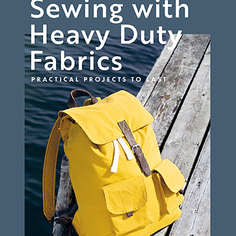 Book cover of 'Sewing with Heavy Duty Fabrics' featuring a yellow backpack on a dock.