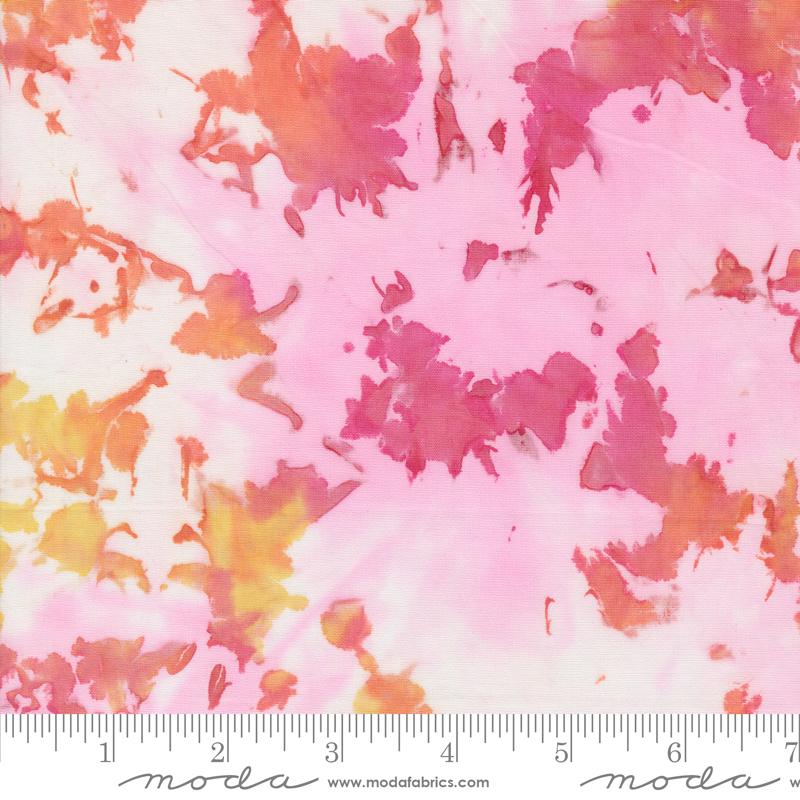 Batik fabric in shades of pink orange on white