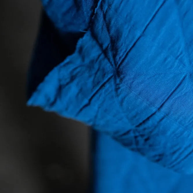 Close-up of blue fabric with a dark background