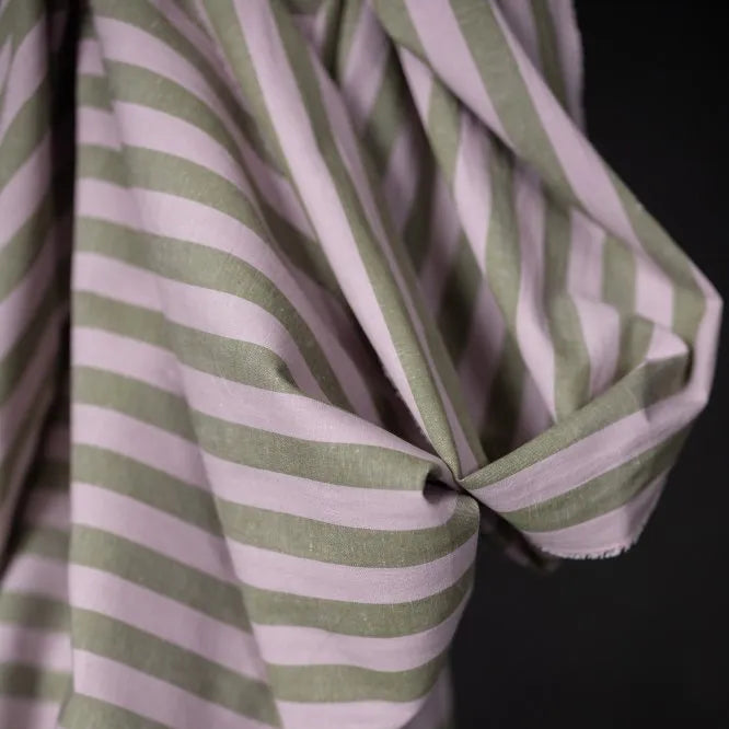 Close-up of a green and white striped fabric against a black background