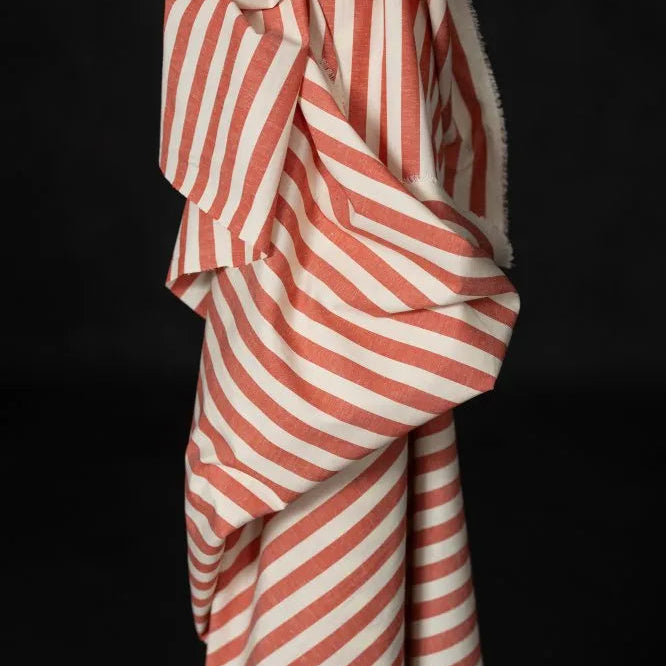 Red and white striped fabric draped over a black background