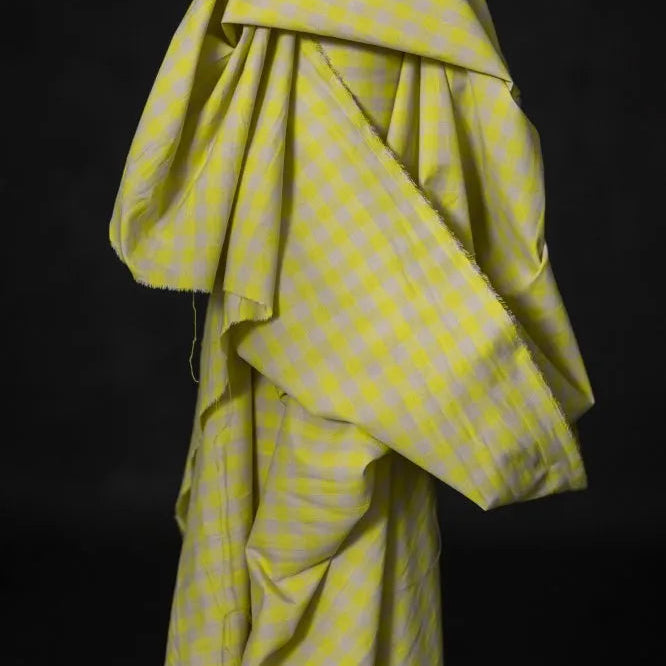 Yellow checkered fabric draped over a black background