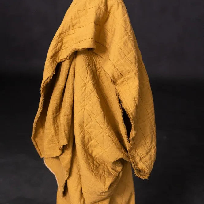 Yellow quilted jacket on a black background