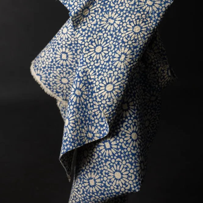 Blue and white patterned fabric on a black background