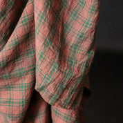 Close-up of a red and green plaid fabric with a dark background