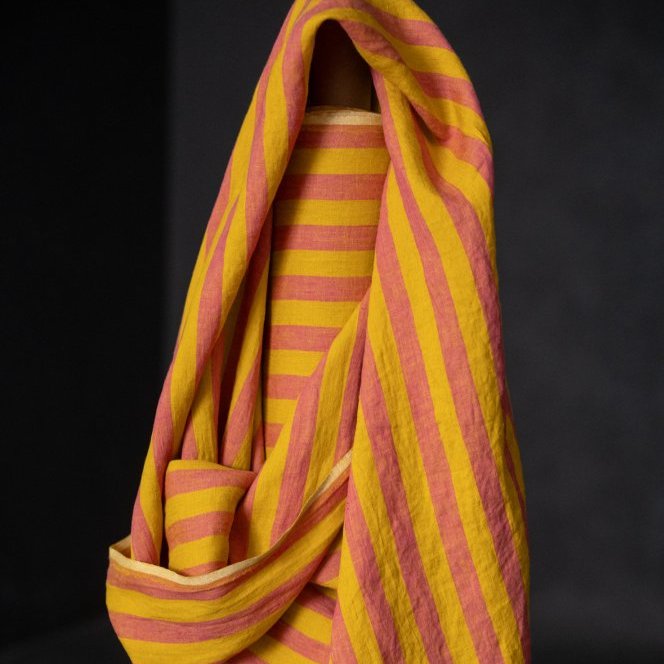 Yellow and pink striped linen fabric on a black background