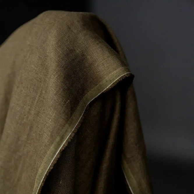 Brown fabric draped over a dark background