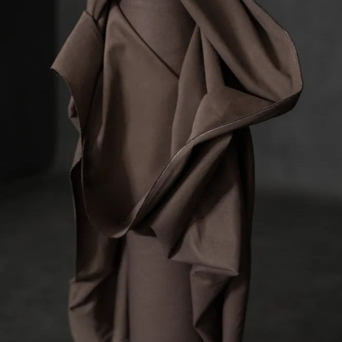 MERCHANT & MILLS Brown fabric draped over a mannequin against a dark background