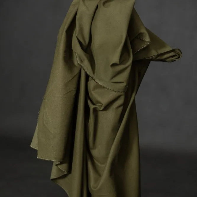 Olive green fabric draped over a dark background