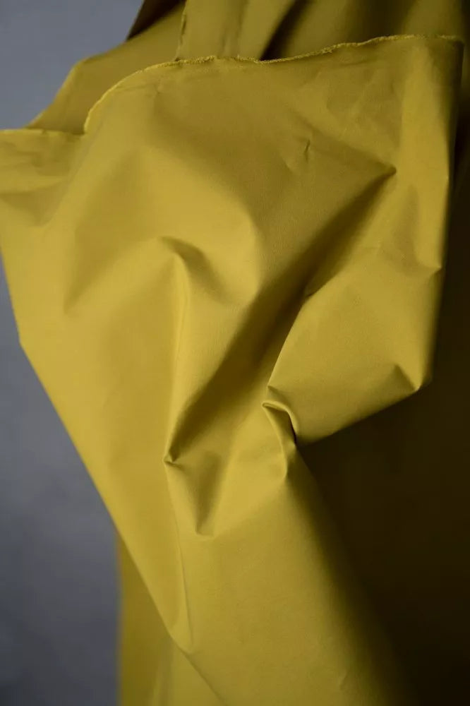 Draped lime green dry oilskin close up