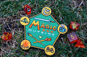 Colorful 'Magic Outside' patch on grass with dice around