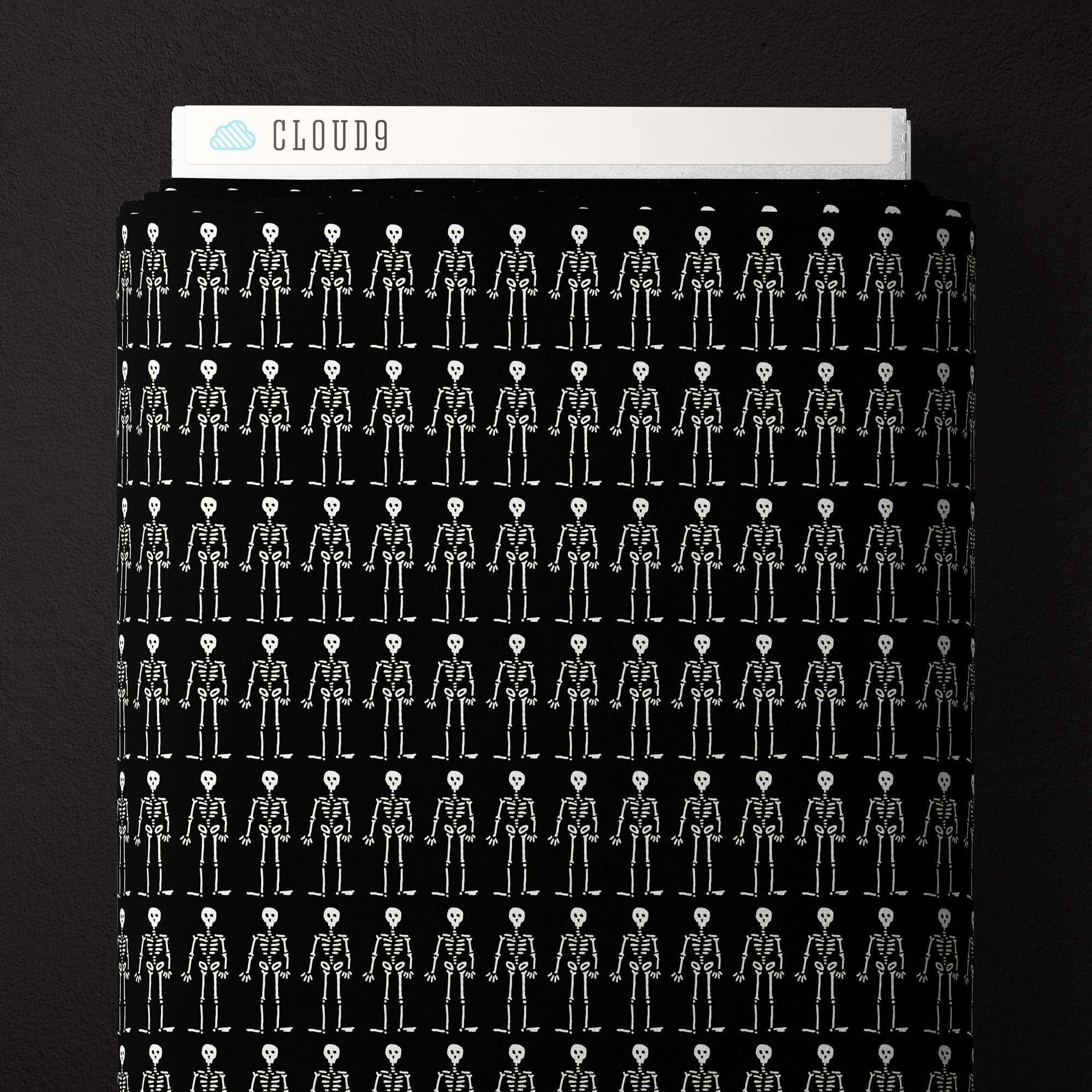 Black fabric with white skeletons on it