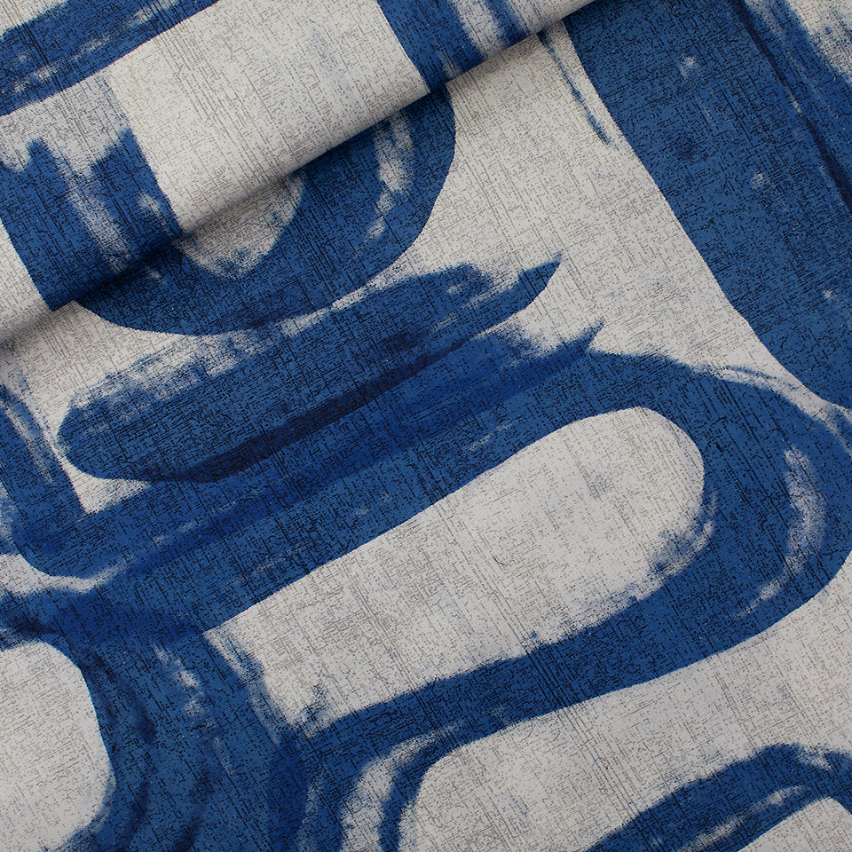 Close-up of a textured fabric with blue and gray abstract pattern