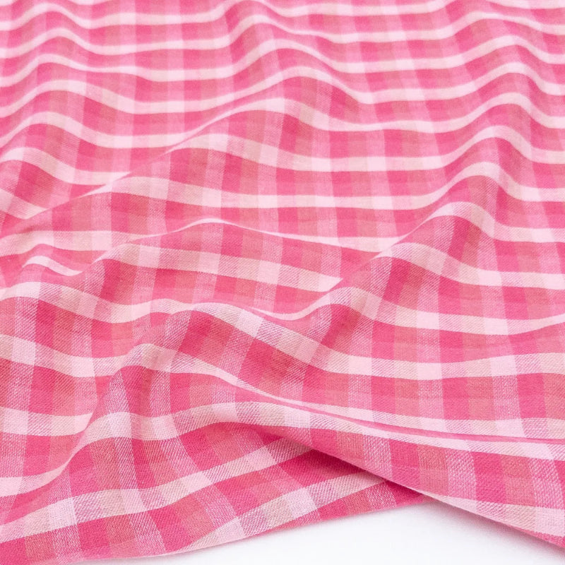 Pink and white checkered fabric on a white background