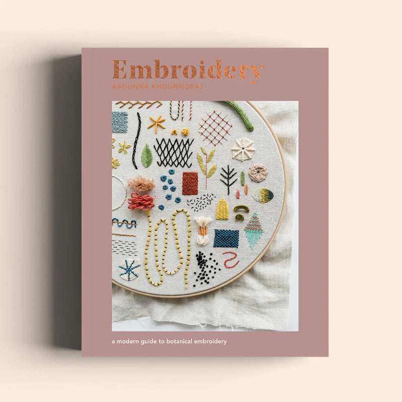 Book cover of 'Embroidery' with an embroidery hoop and various stitches on a beige background
