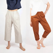 Two women wearing different pants on a white background
