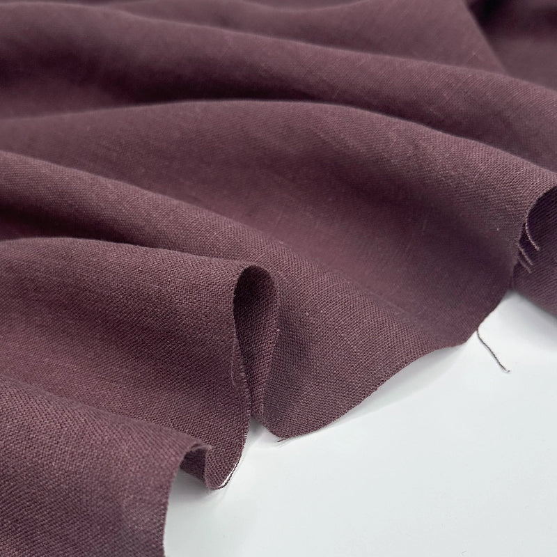 Close-up of dark purple fabric on a white background