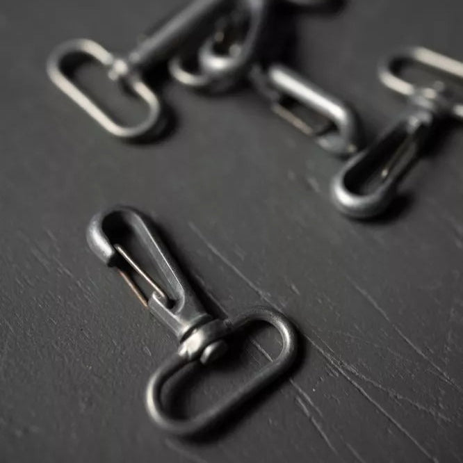 Metallic hooks on a dark surface