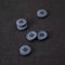 Set of gray buttons on a textured brown fabric background