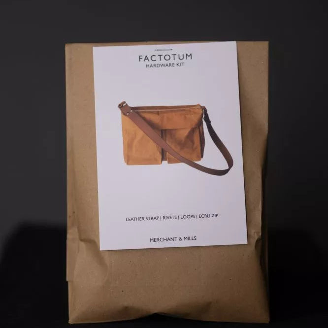Kraft paper package with a leather bag on a white label against a dark background