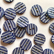 Patterned blue and white buttons on a white background