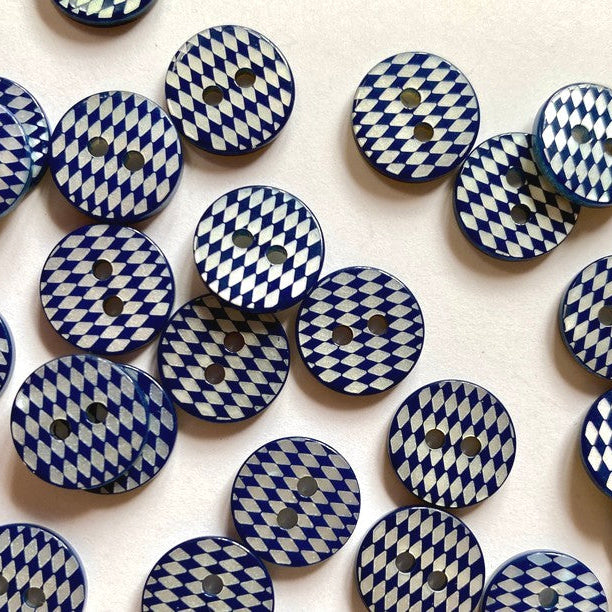 Patterned blue and white buttons on a white background
