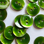 Green buttons with two holes on a white background