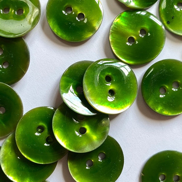 Green buttons with two holes on a white background