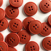 Red buttons with four holes on a white background