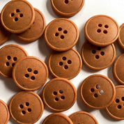 Collection of brown buttons on a white background