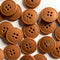 Collection of brown buttons on a white background